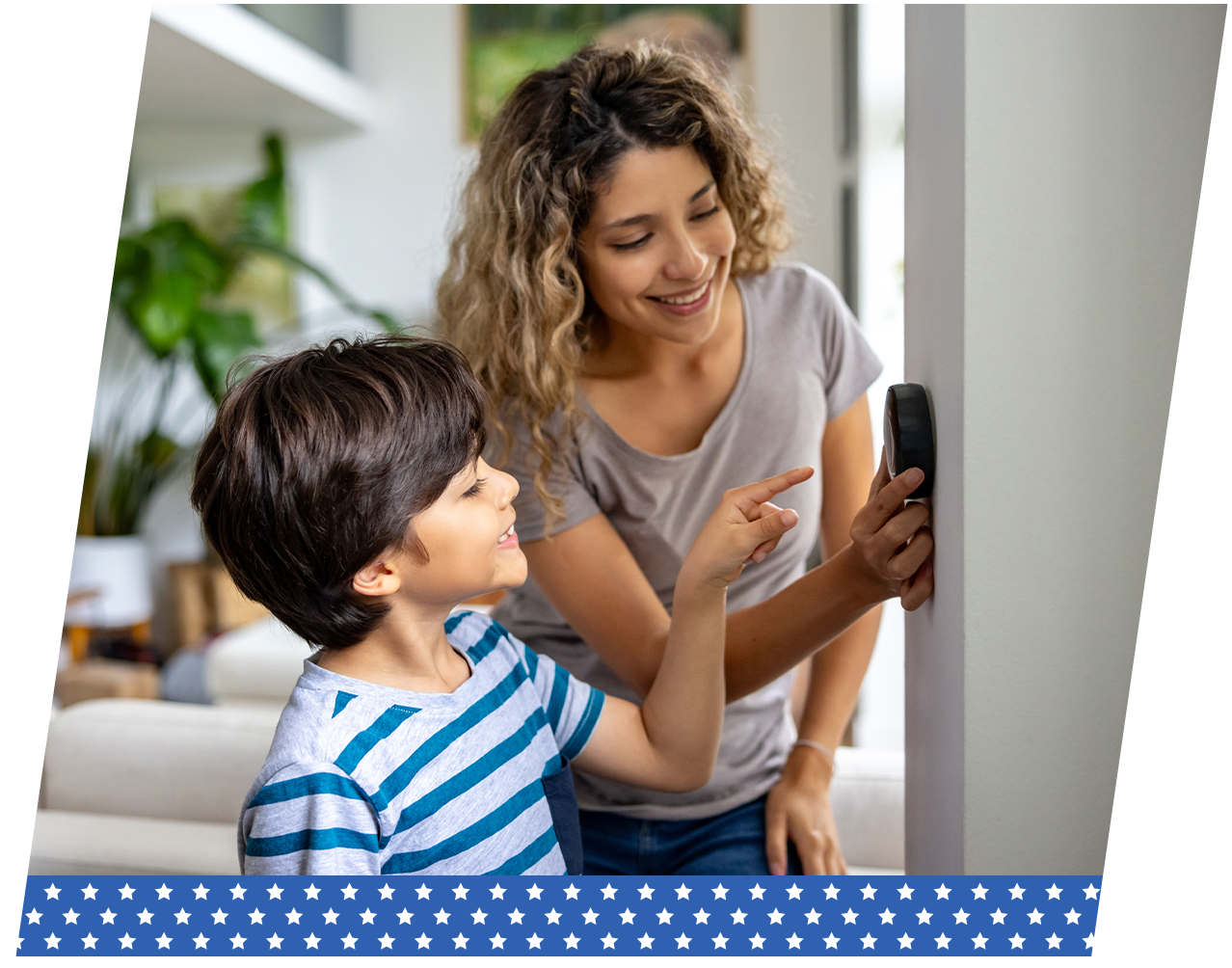 Family adjusting their smart thermostat at home